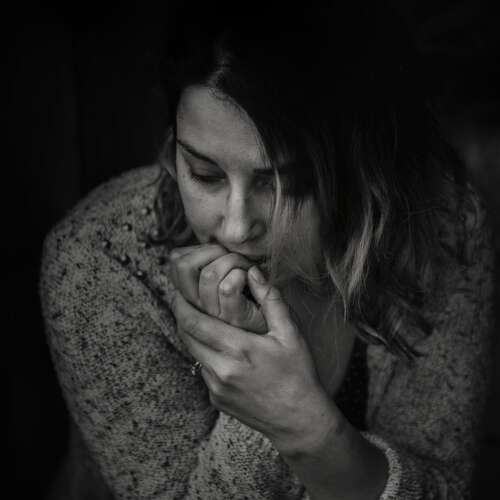 greyscale photography of woman wearing long sleeved top